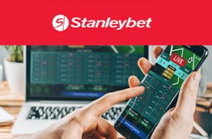 Il logo di Stanleybet e uno scommettitore con uno smartphone e un laptop