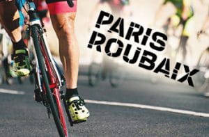 Il logo della Parigi-Roubaix e un ciclista in azione sul pavé